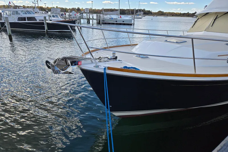 Grayson Yacht Photos Pics 2017 Sabre 48 Fly Bridge yacht docked at marina, calm water, clear sky.