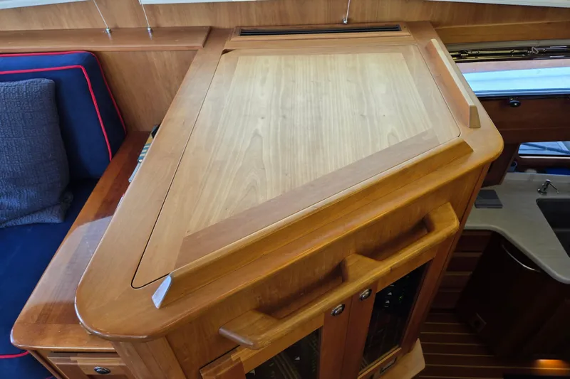 Grayson Yacht Photos Pics Wooden interior of 2017 Sabre 48 Fly Bridge yacht, featuring cabinetry and seating.