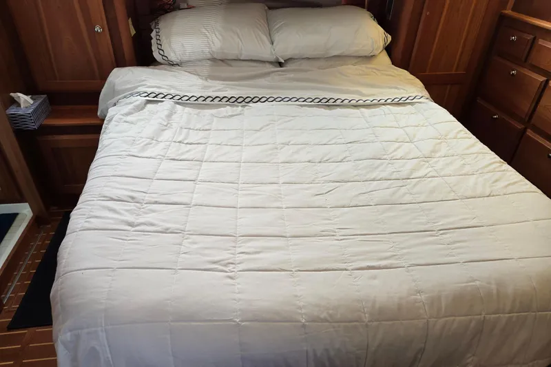 Grayson Yacht Photos Pics Cozy bedroom interior of 2017 Sabre 48 Fly Bridge yacht with wooden cabinetry.