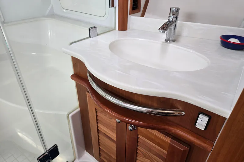 Grayson Yacht Photos Pics Luxurious bathroom sink in 2017 Sabre 48 Fly Bridge yacht with elegant wood cabinetry.