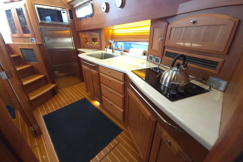 Grayson Yacht Photos Pics Luxurious 2017 Sabre 48 Fly Bridge yacht kitchen with wood cabinetry and modern appliances.