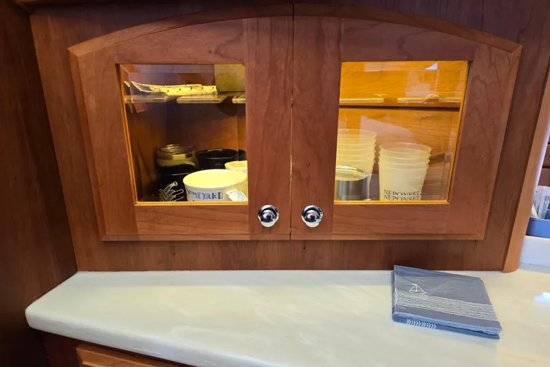 Grayson Yacht Photos Pics Wooden cabinet with glass doors on a 2017 Sabre 48 Fly Bridge yacht.