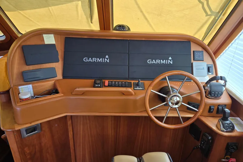 Grayson Yacht Photos Pics 2017 Sabre 48 Fly Bridge helm with Garmin navigation system and wooden steering wheel.