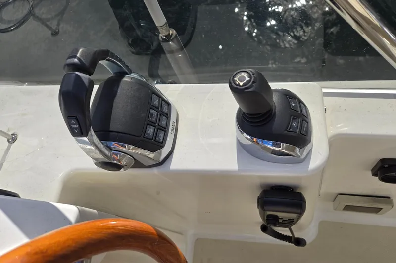 Grayson Yacht Photos Pics Control panel of 2017 Sabre 48 Fly Bridge yacht with throttle and joystick.