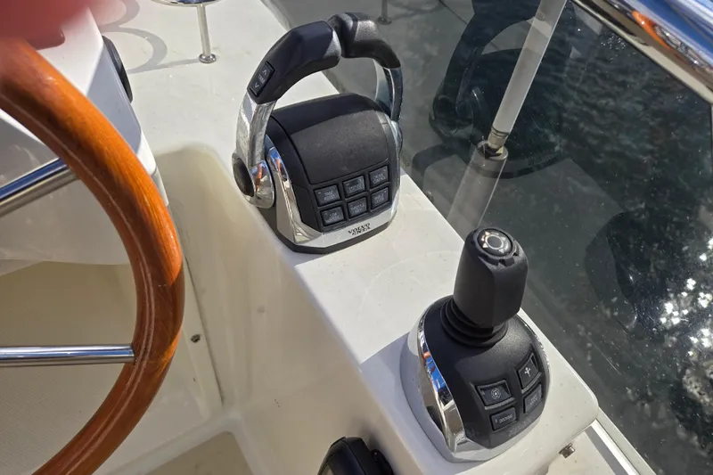 Grayson Yacht Photos Pics Control panel of 2017 Sabre 48 Fly Bridge yacht with joystick and throttle.