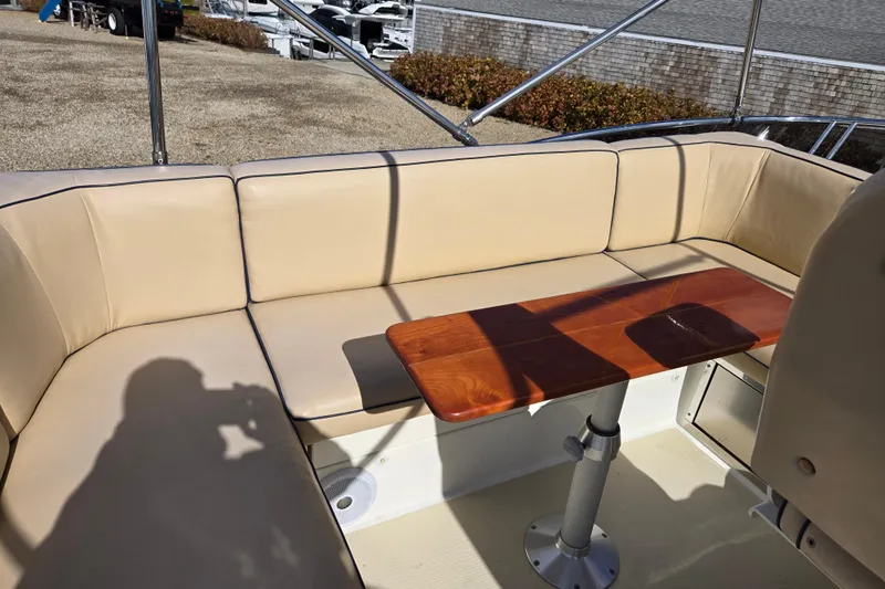 Grayson Yacht Photos Pics Flybridge seating area on 2017 Sabre 48 Fly Bridge with wooden table.