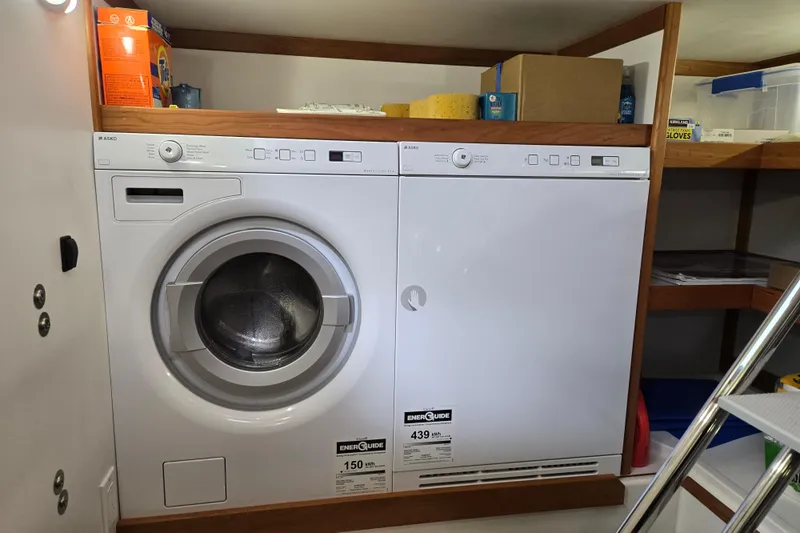 Grayson Yacht Photos Pics Laundry area with Asko washer and dryer on Sabre 48 Fly Bridge yacht, 2017 model.