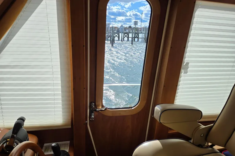 Grayson Yacht Photos Pics Interior view from 2017 Sabre 48 Fly Bridge, showcasing water and dock through door.