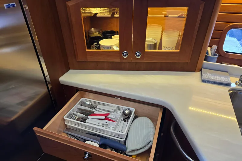 Grayson Yacht Photos Pics 2017 Sabre 48 Fly Bridge kitchen with open drawer, utensils, and countertop.