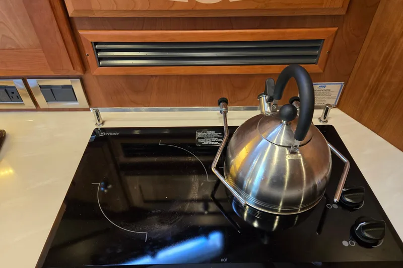 Grayson Yacht Photos Pics Stainless steel kettle on induction stove in 2017 Sabre 48 Fly Bridge yacht kitchen.