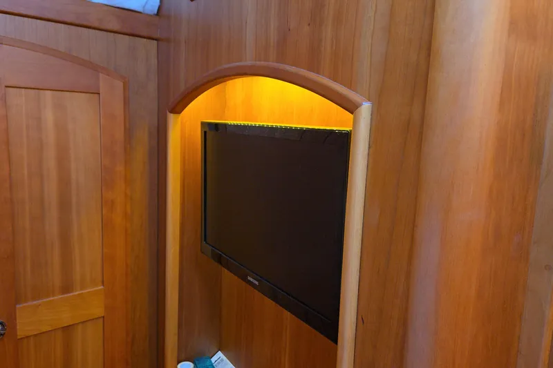 Grayson Yacht Photos Pics Wall-mounted TV in wooden interior of 2017 Sabre 48 Fly Bridge yacht.