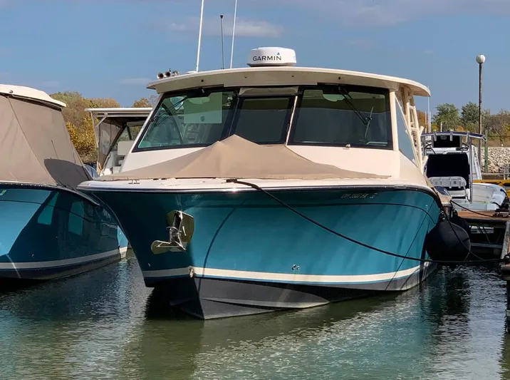  Yacht Photos Pics 2019 Grady-White Freedom 375 boat docked in marina, featuring a sleek blue hull.