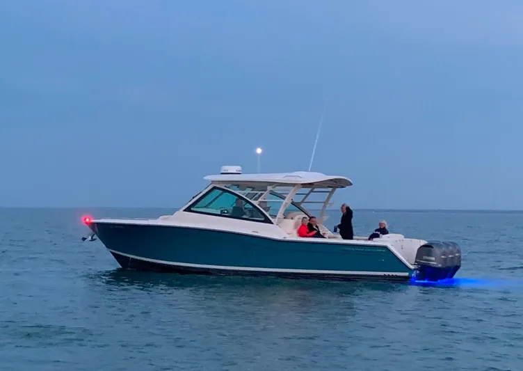  Yacht Photos Pics 2019 Grady-White Freedom 375 boat on calm water at dusk.