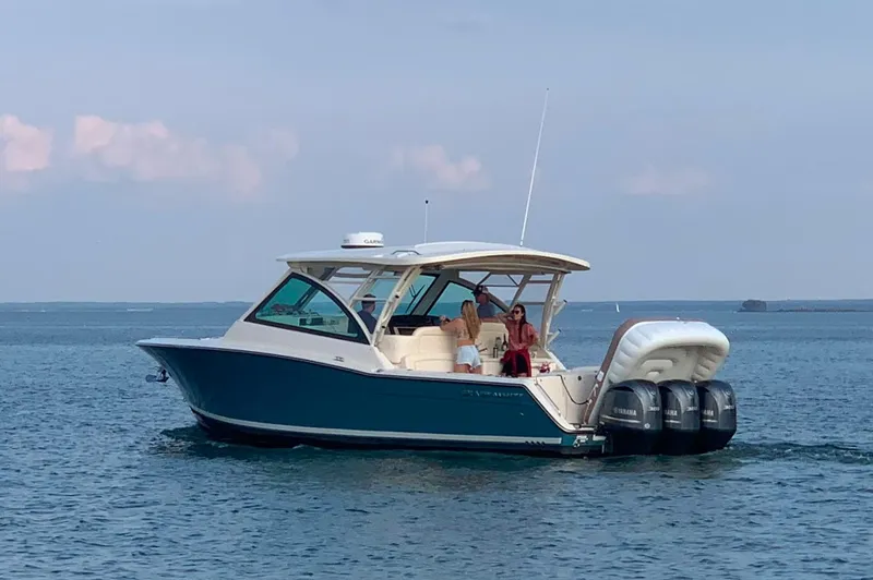 Yacht Photos Pics 2019 Grady-White Freedom 375 boat cruising on calm waters with passengers onboard.
