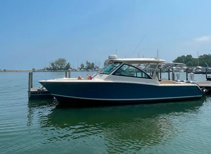  Yacht Photos Pics 2019 Grady-White Freedom 375 boat docked in a marina under clear blue skies.