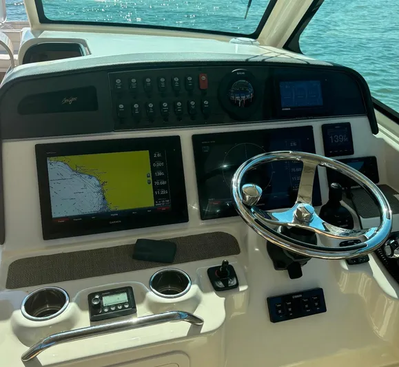  Yacht Photos Pics 2019 Grady-White Freedom 375 boat dashboard with navigation screens and steering wheel.