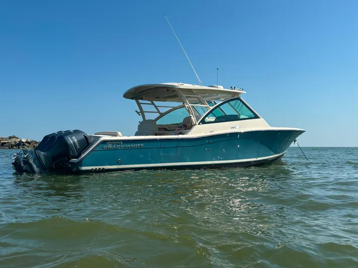  Yacht Photos Pics 2019 Grady-White Freedom 375 boat on calm water under clear blue sky.