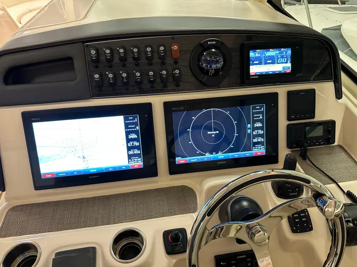  Yacht Photos Pics Control panel of 2019 Grady-White Freedom 375 boat with navigation screens and steering wheel.