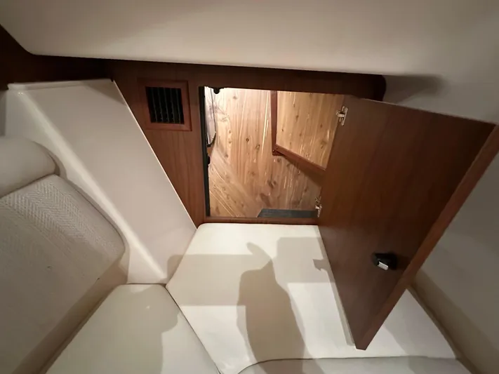  Yacht Photos Pics 2019 Grady-White Freedom 375 cabin interior with open wooden door and seating area.