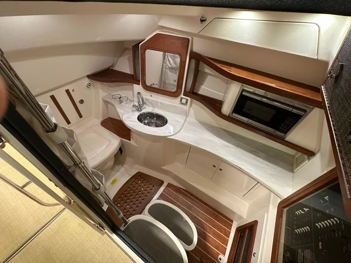  Yacht Photos Pics 2019 Grady-White Freedom 375 cabin interior with sink, toilet, and microwave.