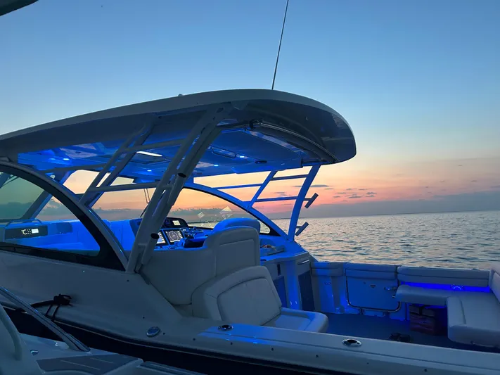  Yacht Photos Pics 2019 Grady-White Freedom 375 boat at sunset, featuring blue interior lighting.