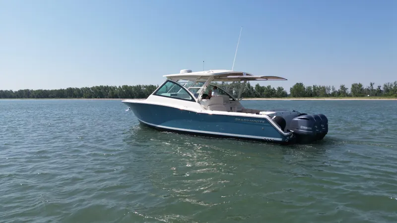  Yacht Photos Pics 2019 Grady-White Freedom 375 boat on calm water, clear sky background.