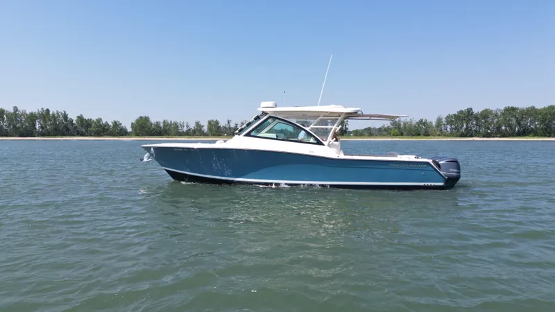  Yacht Photos Pics 2019 Grady-White Freedom 375 boat on calm water, clear sky background.