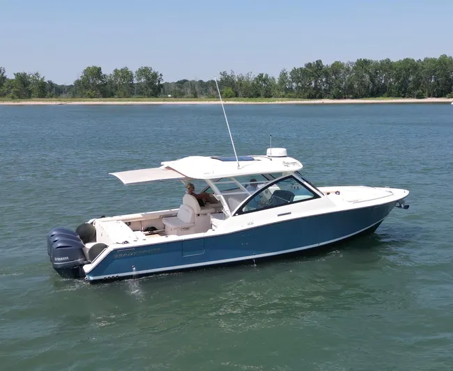 Yacht Photos Pics 2019 Grady-White Freedom 375 boat cruising on a calm lake.