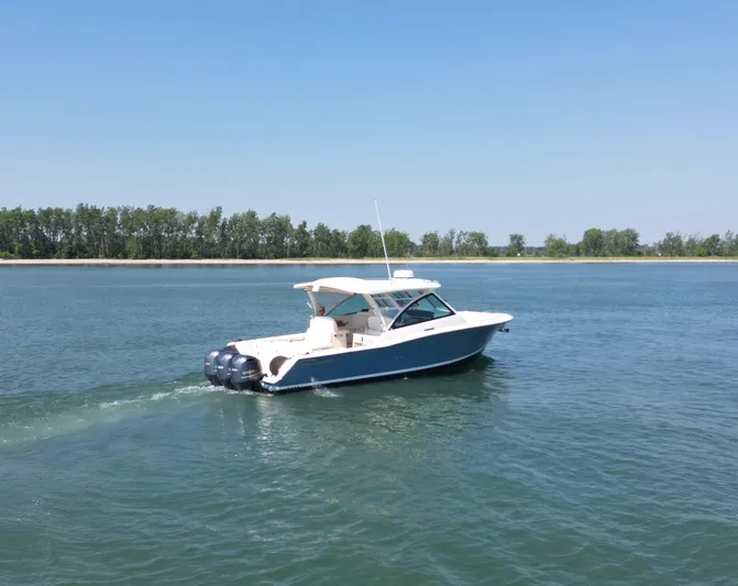  Yacht Photos Pics 2019 Grady-White Freedom 375 boat cruising on a calm lake.