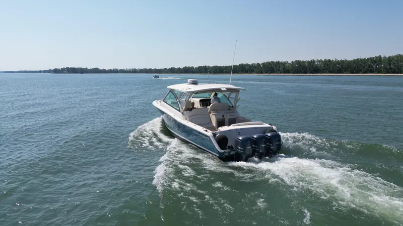  Yacht Photos Pics 2019 Grady-White Freedom 375 boat cruising on a calm lake.