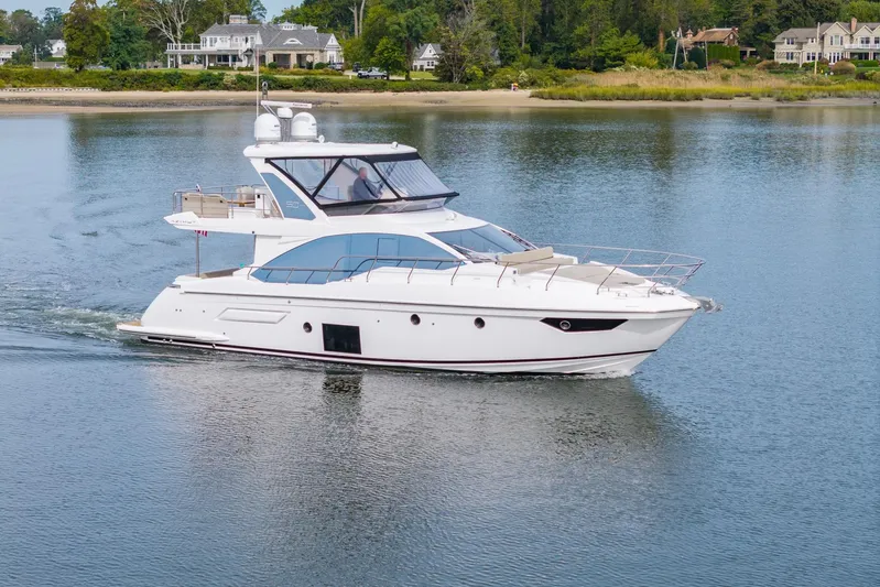  Yacht Photos Pics 2020 Azimut Fly 50 yacht cruising on calm waters near a scenic shoreline.