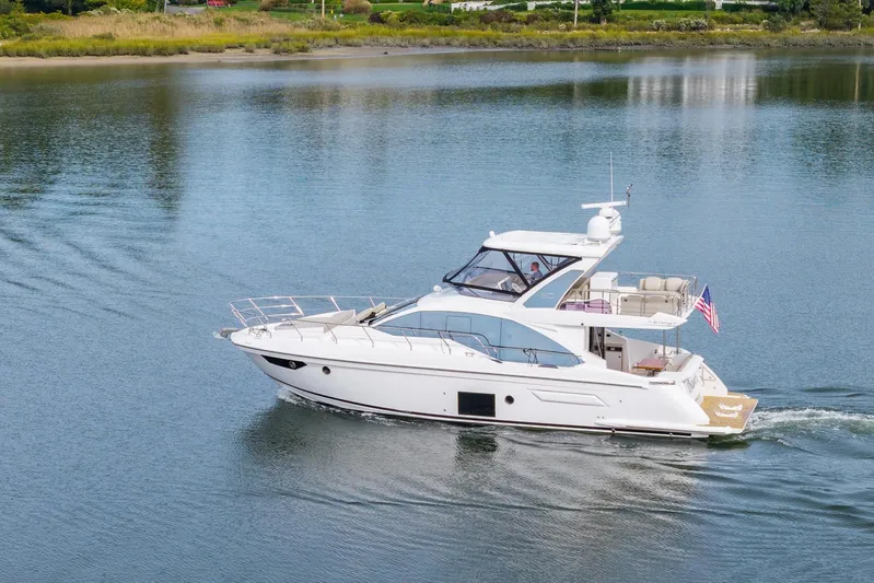  Yacht Photos Pics 2020 Azimut Fly 50 yacht cruising on a calm lake with lush greenery.