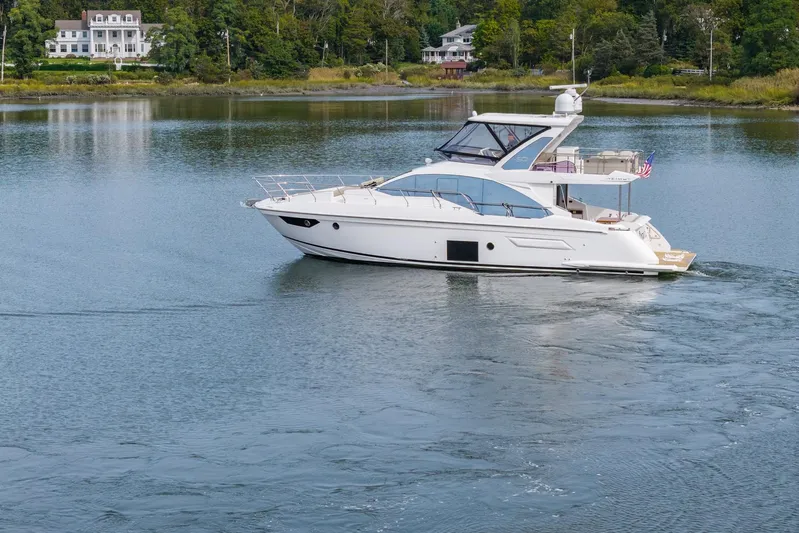  Yacht Photos Pics 2020 Azimut Fly 50 yacht cruising on a serene lake with lush greenery.