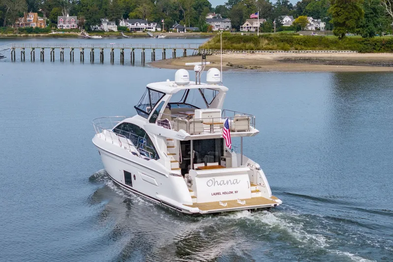  Yacht Photos Pics Azimut Fly 50 yacht cruising near shoreline, 2020 model, with American flag displayed.