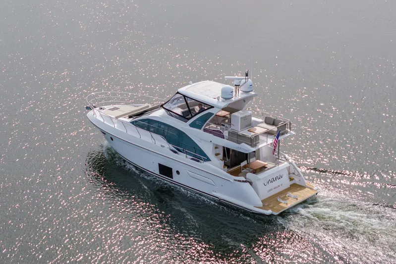  Yacht Photos Pics 2020 Azimut Fly 50 yacht cruising on sparkling water, rear view.