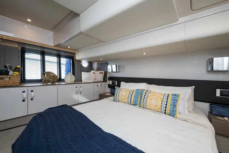  Yacht Photos Pics Luxurious bedroom interior of 2020 Azimut Fly 50 yacht with modern decor and cozy bedding.