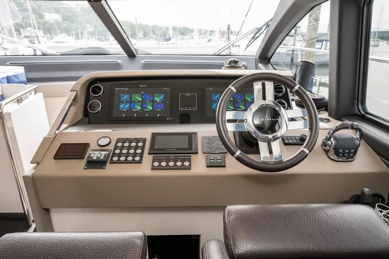  Yacht Photos Pics Cockpit of 2020 Azimut Fly 50 yacht with modern navigation controls and leather steering wheel.