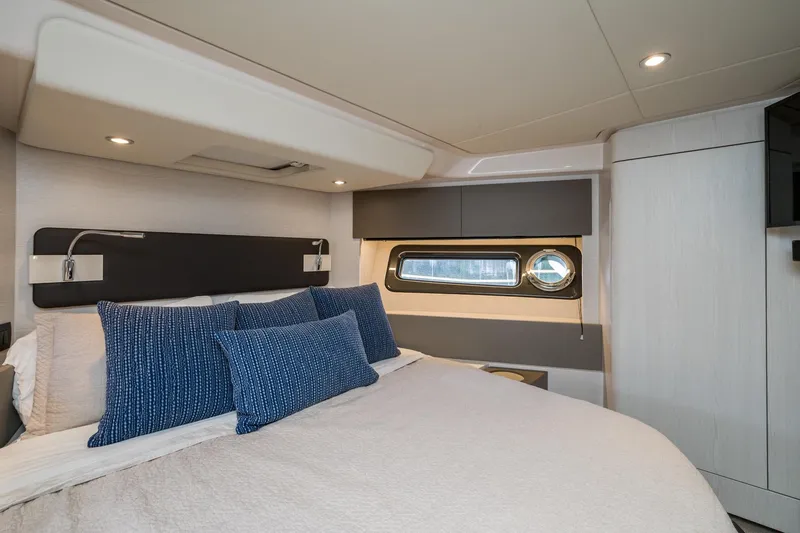  Yacht Photos Pics Luxurious bedroom interior of 2020 Azimut Fly 50 yacht with modern design and blue accents.