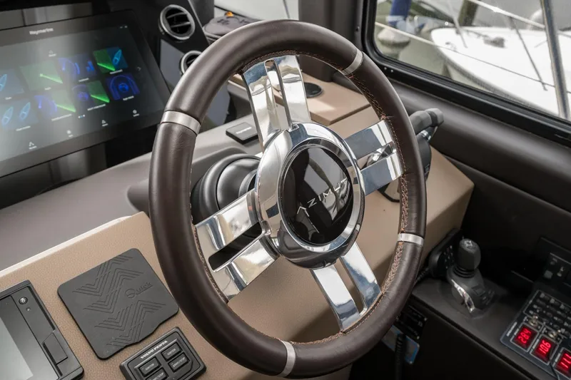  Yacht Photos Pics Steering wheel and dashboard of 2020 Azimut Fly 50 yacht, featuring modern controls.