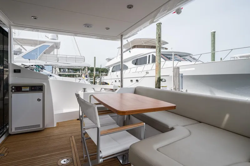  Yacht Photos Pics 2020 Azimut Fly 50 yacht deck with seating and table, docked at marina.