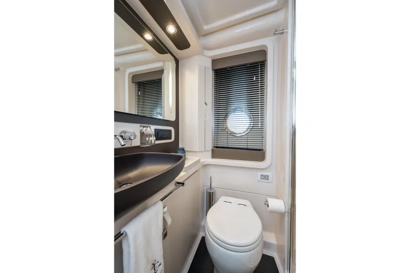  Yacht Photos Pics Luxurious bathroom in 2020 Azimut Fly 50 yacht with modern fixtures and porthole window.