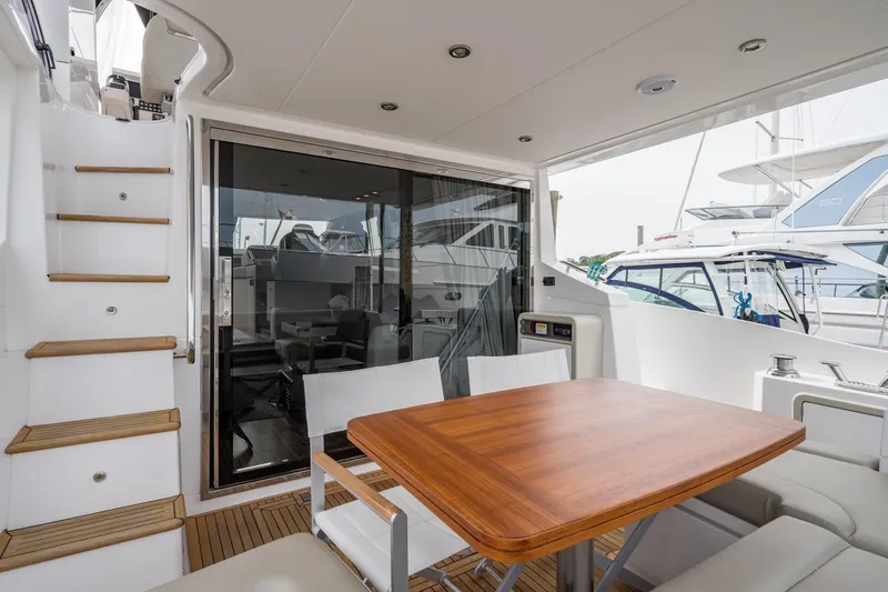  Yacht Photos Pics Azimut Fly 50 yacht deck with wooden table and seating, 2020 model.