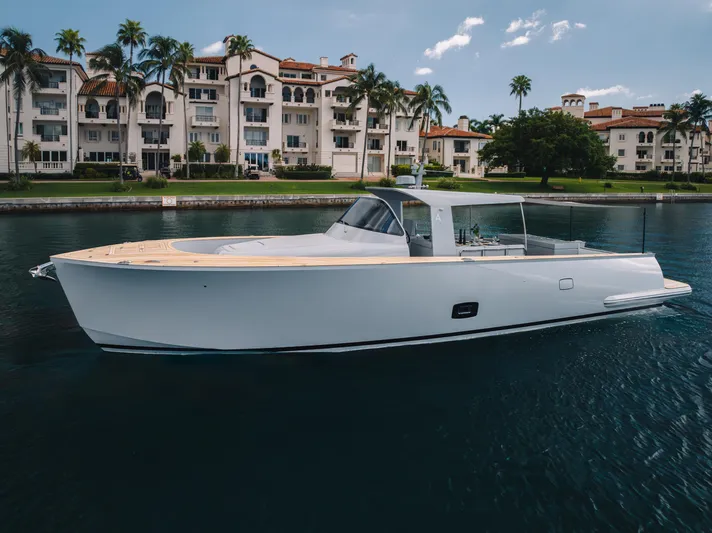 M/y Valor Yacht Photos Pics 2021 Alen 55 yacht cruising near luxury waterfront residences.