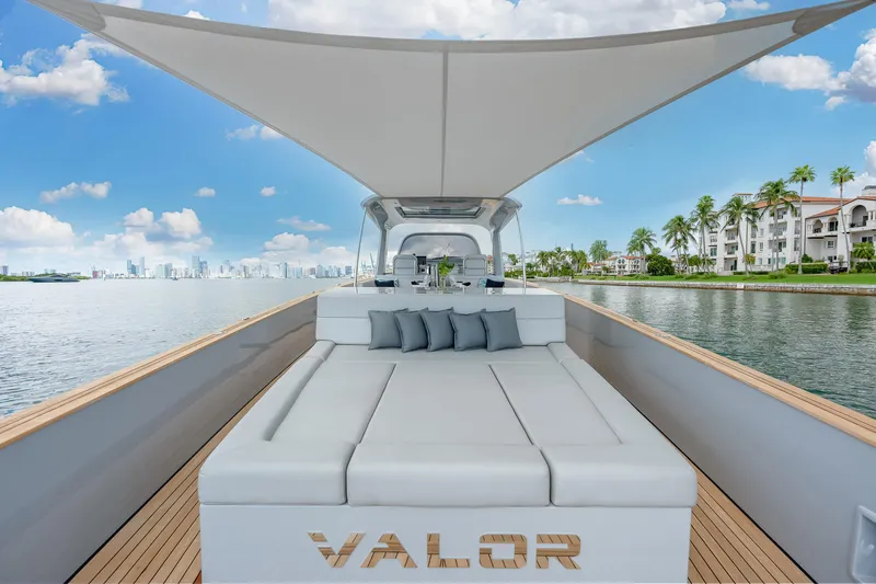M/y Valor Yacht Photos Pics Luxury Alen 55 yacht, 2021 model, with sunbed and canopy, cruising near waterfront homes.