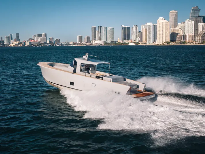 M/y Valor Yacht Photos Pics 2021 Alen 55 yacht cruising near city skyline on a sunny day.