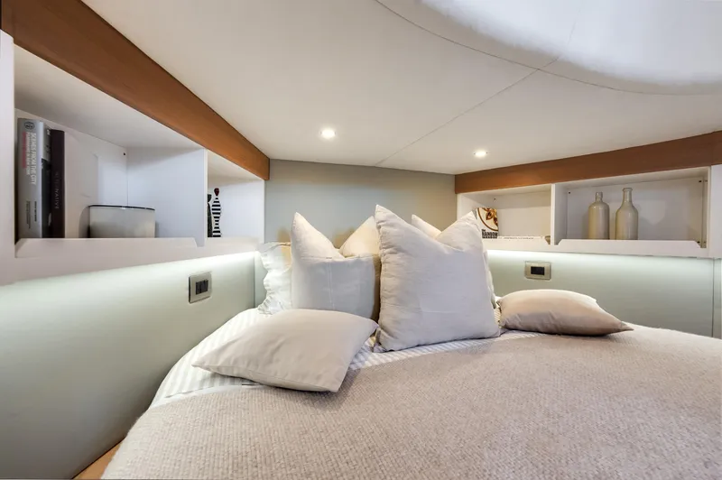 M/y Valor Yacht Photos Pics Luxurious bedroom interior of 2021 Alen 55 yacht with cozy bedding and ambient lighting.