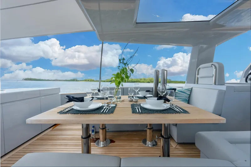 M/y Valor Yacht Photos Pics Luxurious dining setup on 2021 Alen 55 yacht with ocean view.