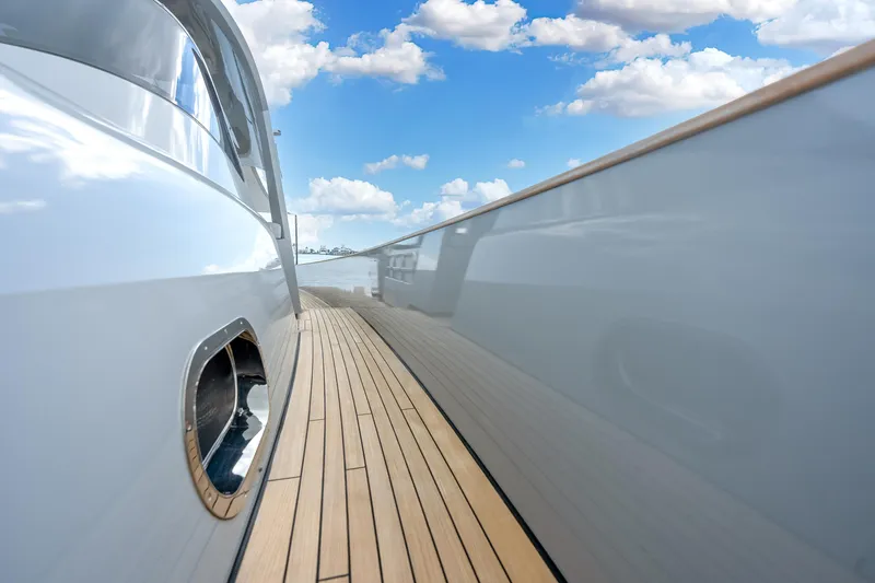 M/y Valor Yacht Photos Pics Sleek Alen 55 yacht deck, 2021 model, with polished wood and reflective surfaces under blue sky.