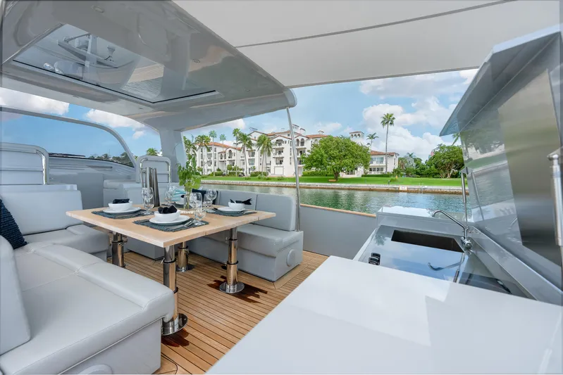 M/y Valor Yacht Photos Pics Luxurious 2021 Alen 55 yacht interior with elegant dining setup and scenic waterfront view.