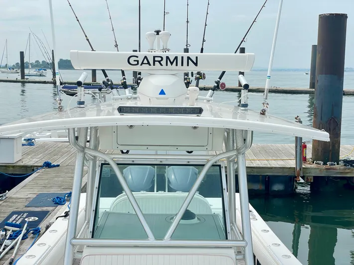 Helm Master Ex Joystick Yacht Photos Pics Regulator 32FS boat with Garmin equipment docked, featuring multiple fishing rods.